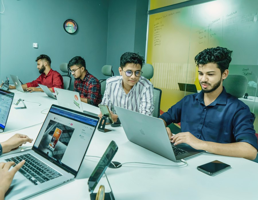 Dwitech team members collaborating at their desks in the company office