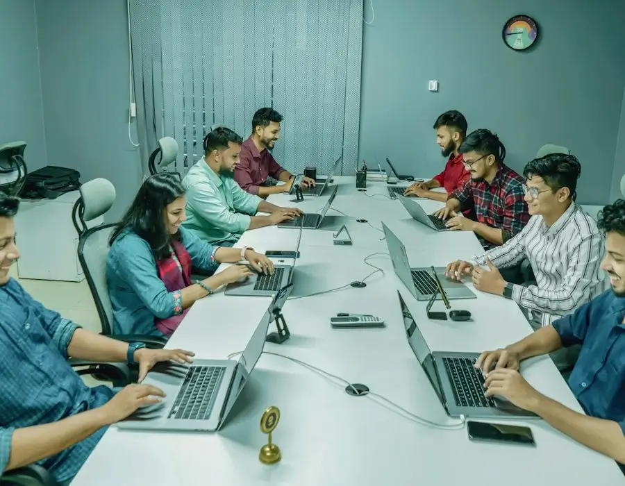 Dwitech team members working at their desks in the company office